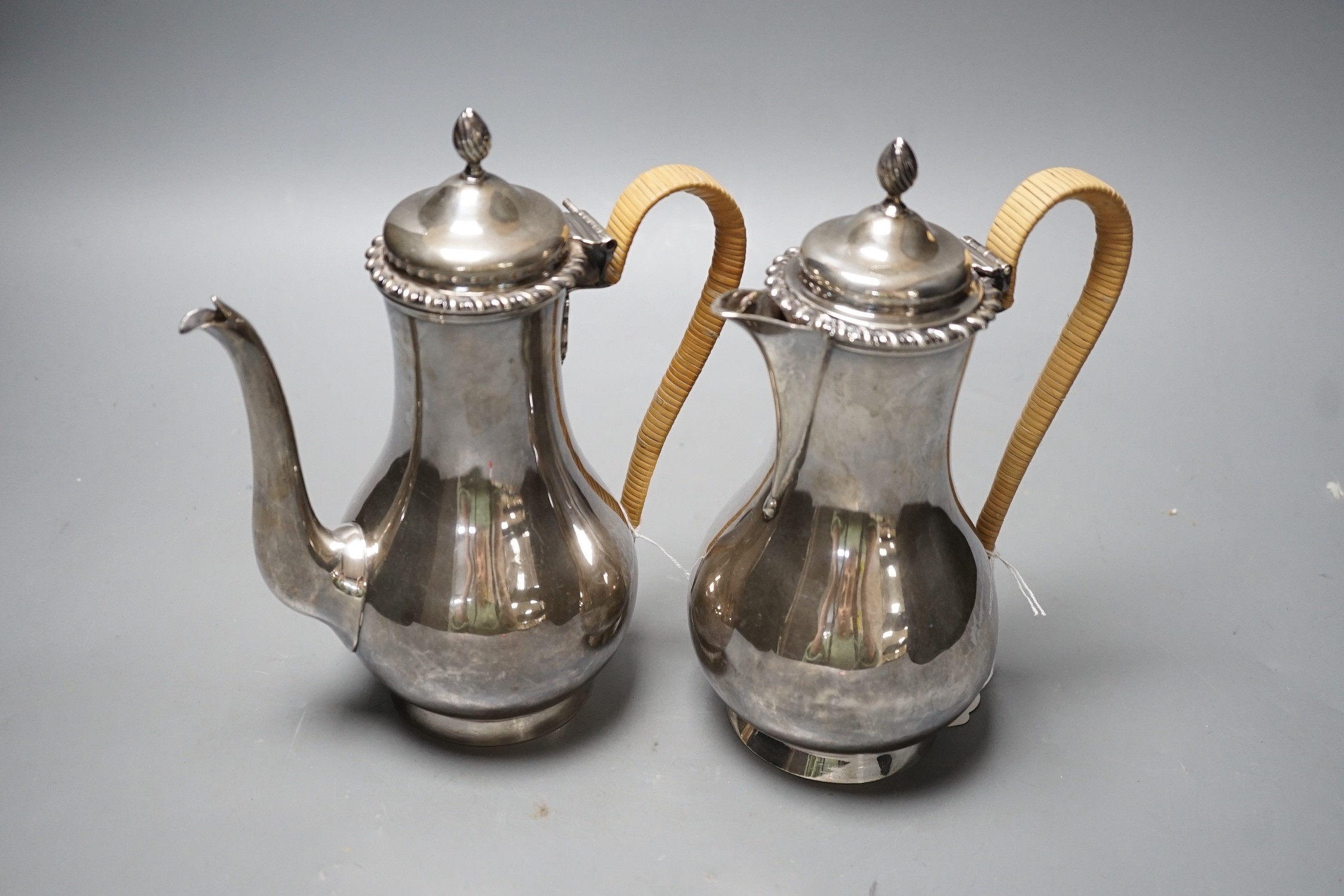 A matched early 20th century silver cafe au lait pair, London, 1900 & 1903, one by Edward Charles Purdie, height 21cm et infra, gross weight 31.1oz.
